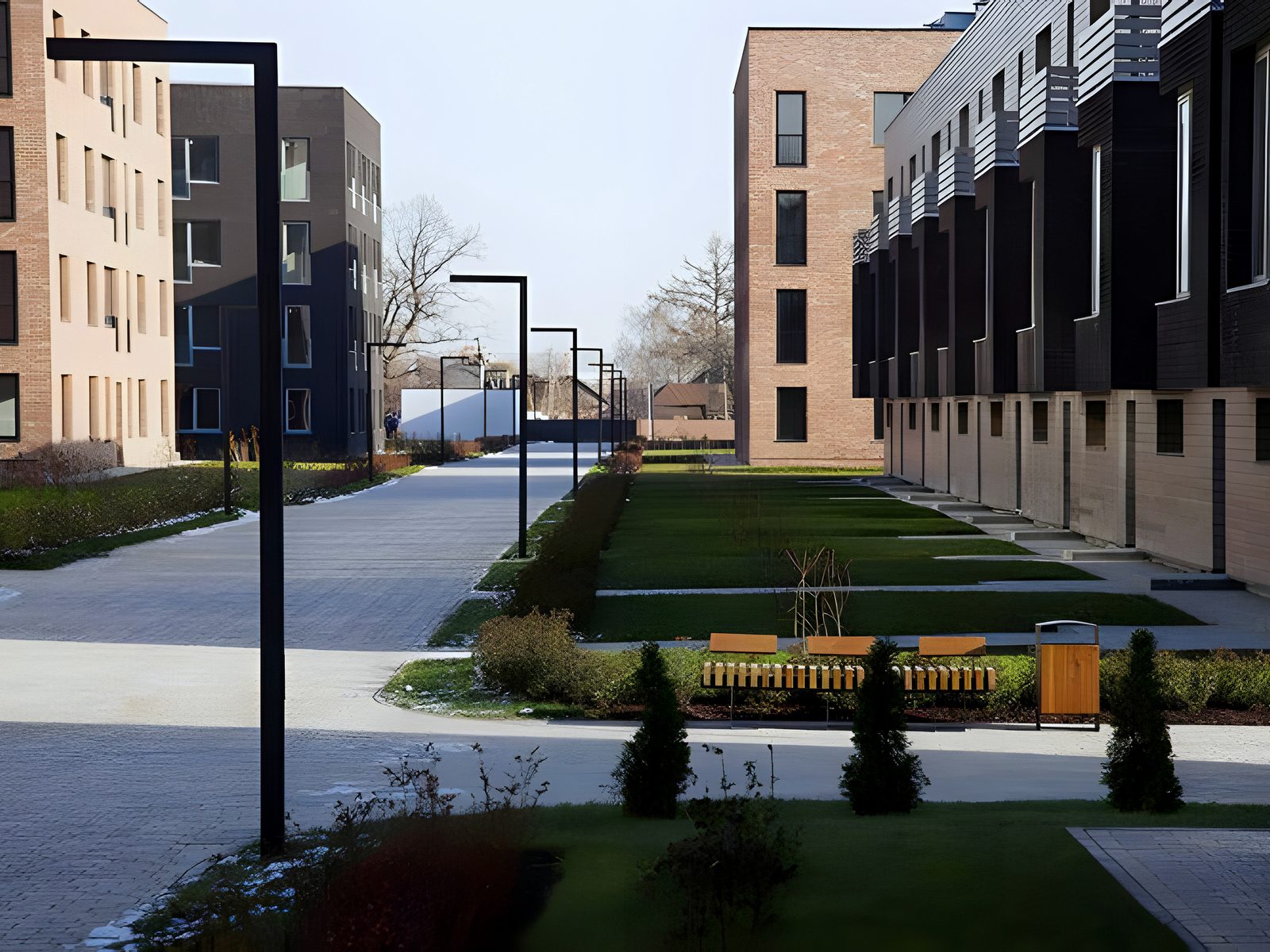 Landscaped courtyard between brick apartment blocks and townhouses