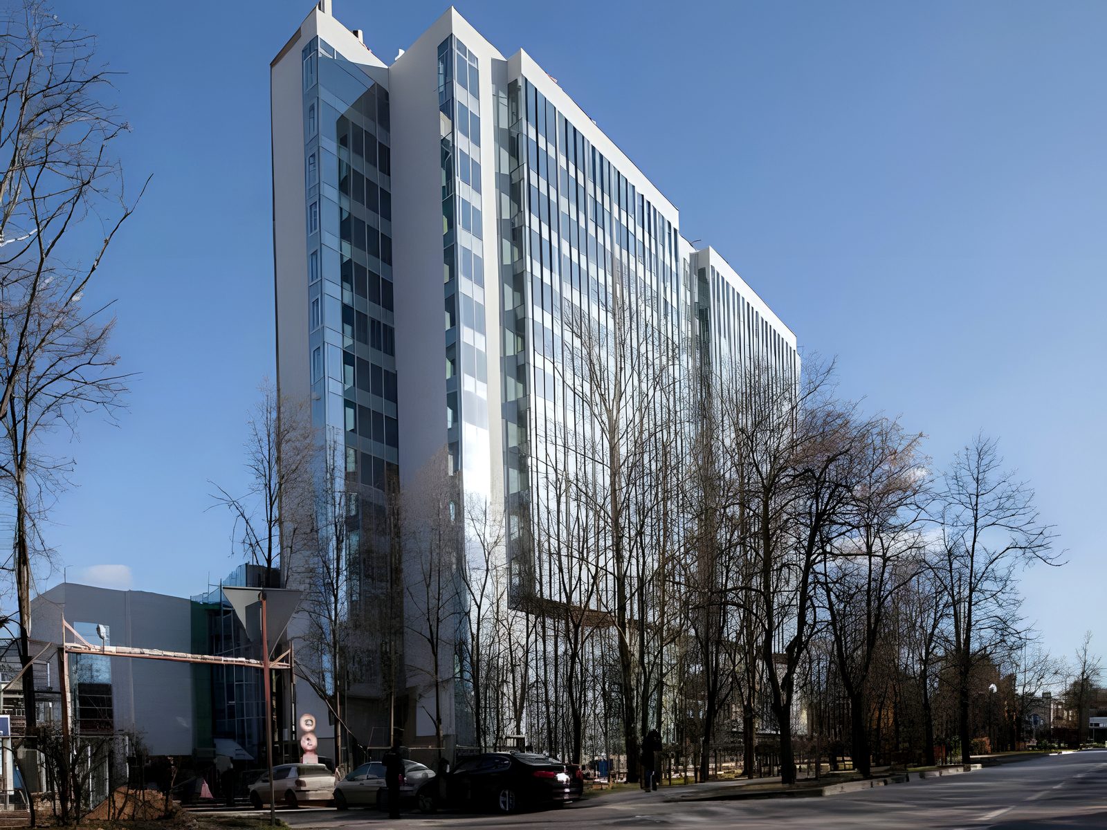 Completed hotel tower from the street under a clear blue sky