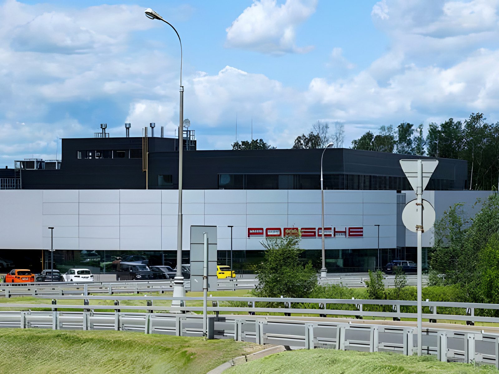 Car dealership and service complex seen across a highway