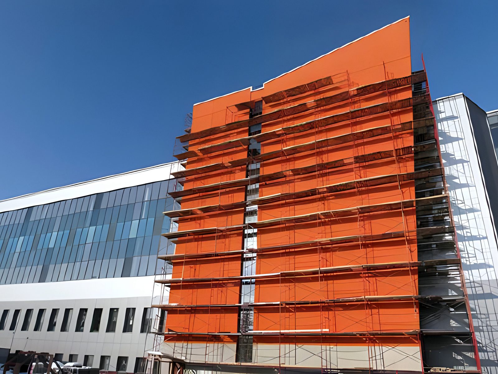 Terminal wing under construction, orange cladding and scaffolding