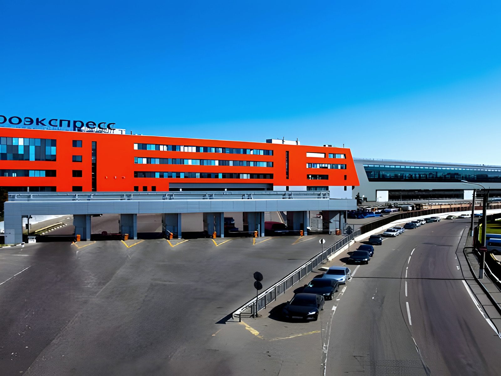 Red station block spanning the airport approach road