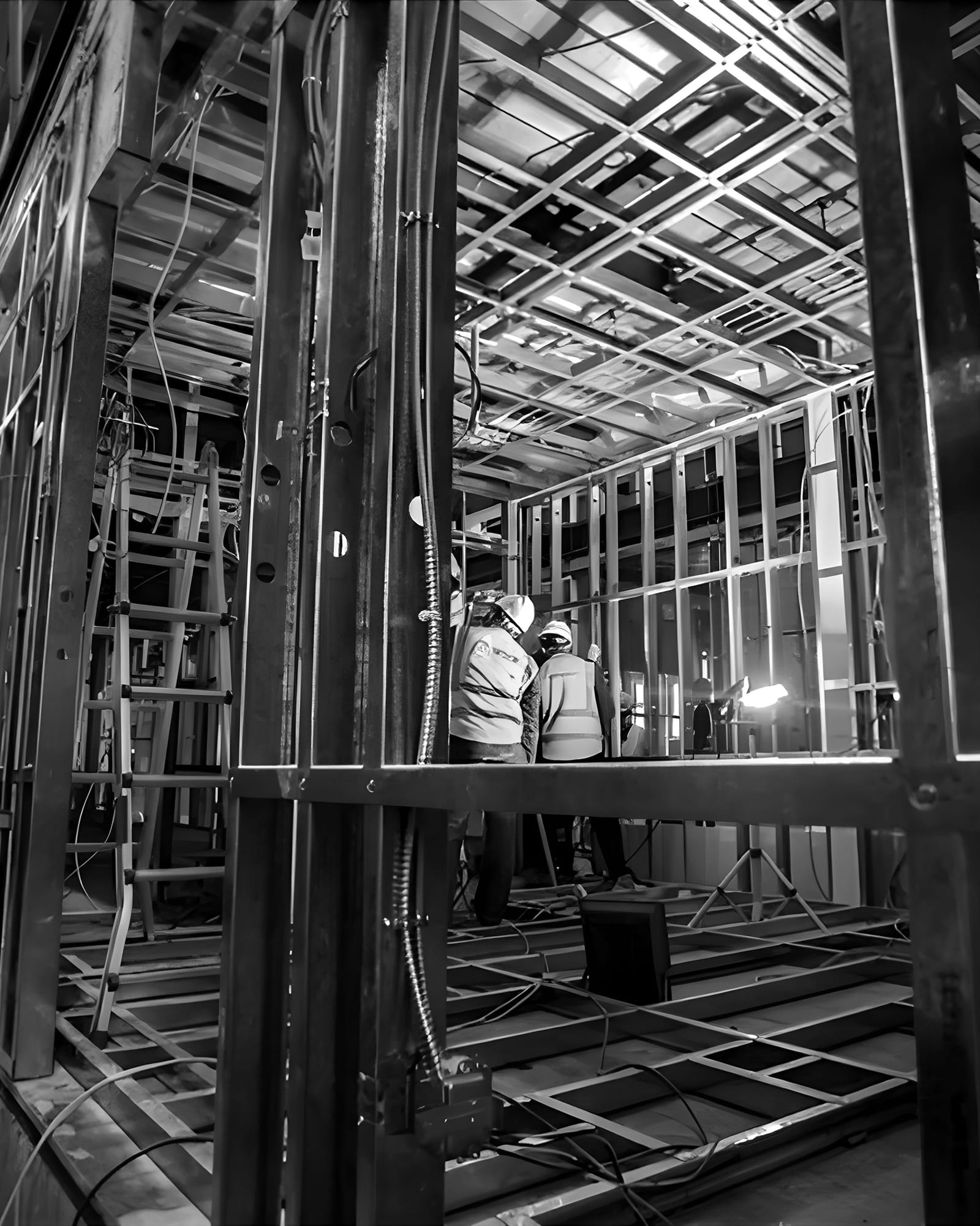 Workers assembling steel-framed modules inside the production hall