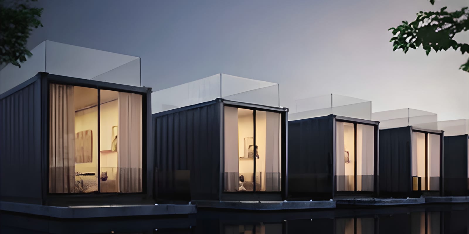 Row of dark modular bungalows lit at dusk over water