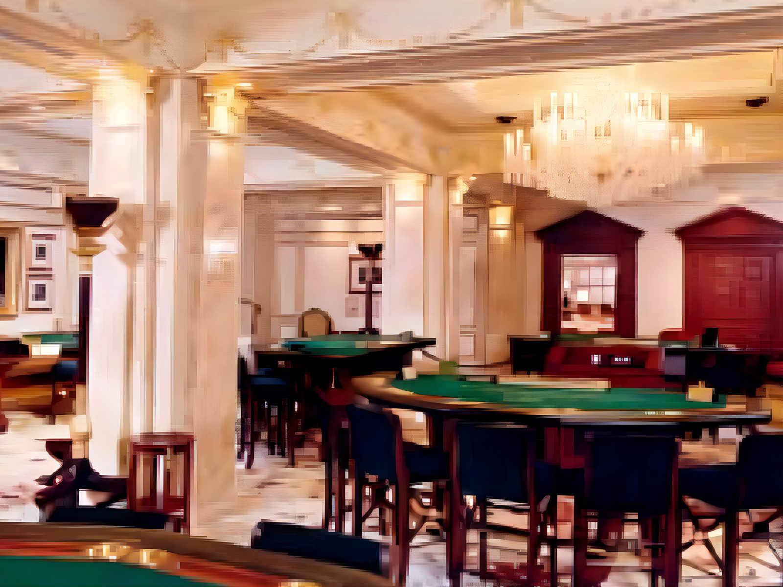 Casino gaming room: green baize tables between marble columns under a crystal chandelier, with timber gaming booths at the back