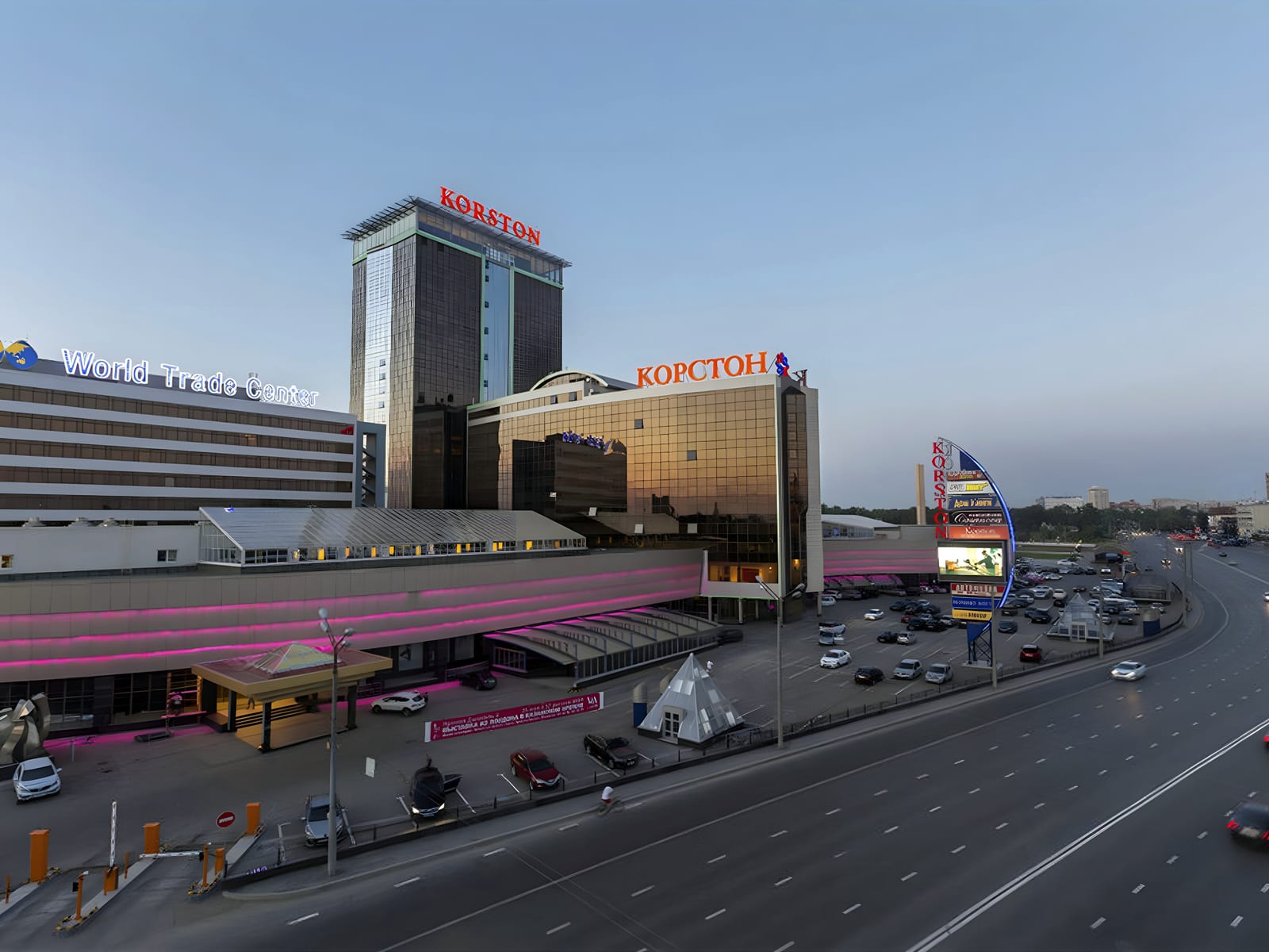 Hotel and mall complex in Kazan at dusk beside a highway