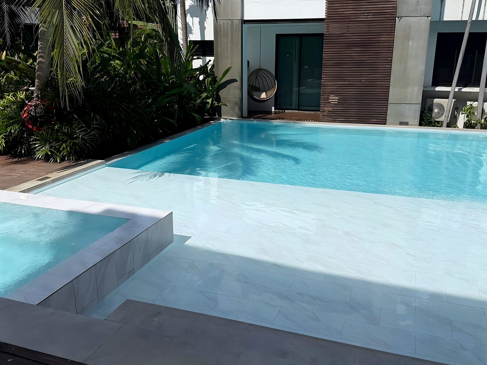 Swimming pool and white marble deck at the single-family residence in Bal Harbour, Florida